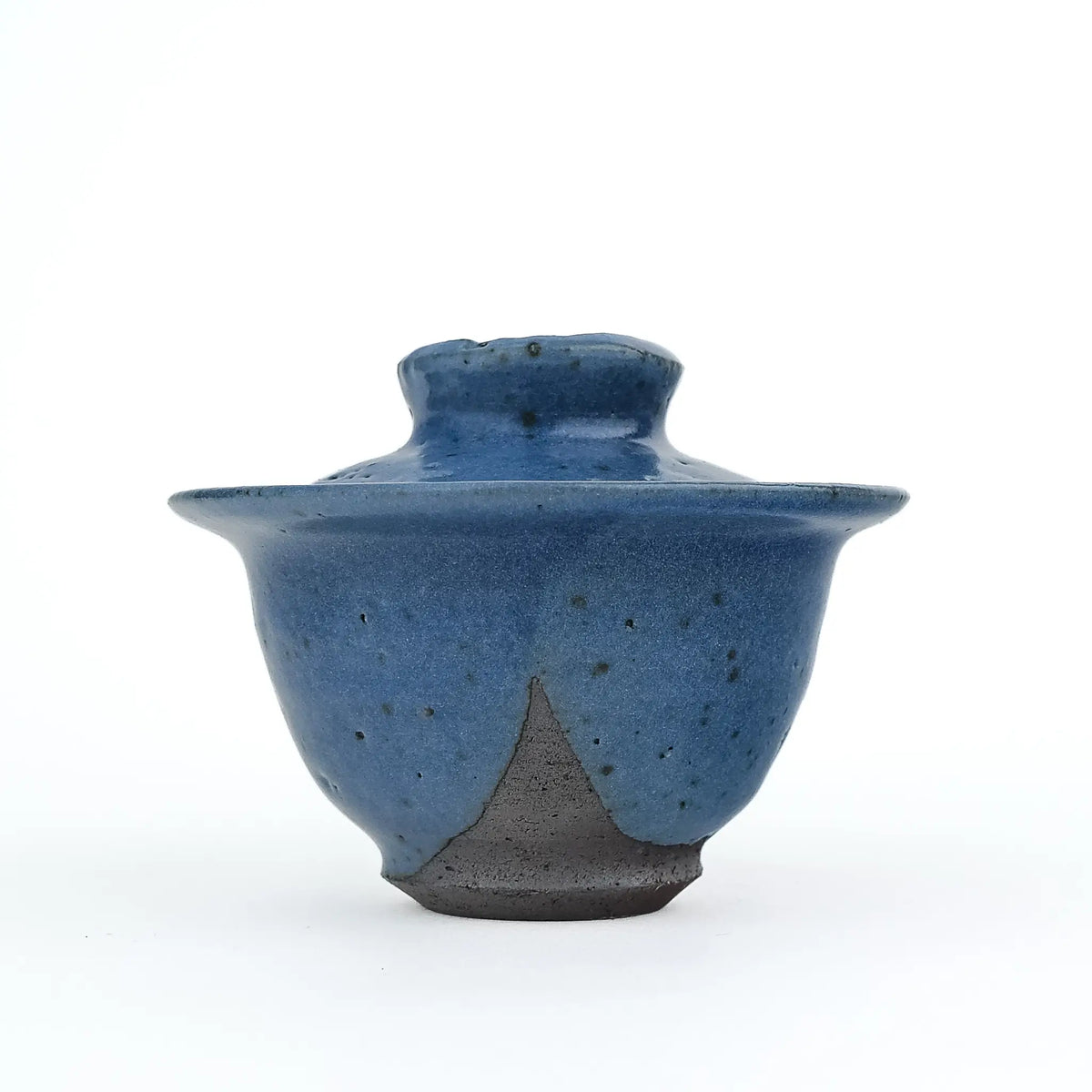 Mark Mohler handmade gaiwan #12, about 90 ml, at eye level with the lid on, in a speckled blue glaze that stops in a point above the dark unglazed foot