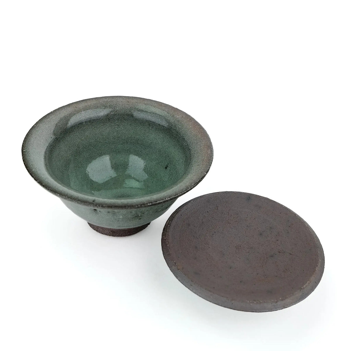 Mark Mohler handmade gaiwan #8 with the lid off and turned over beside the bowl, showing the glossy green glaze inside the bowl and the unglazed underside of the lid