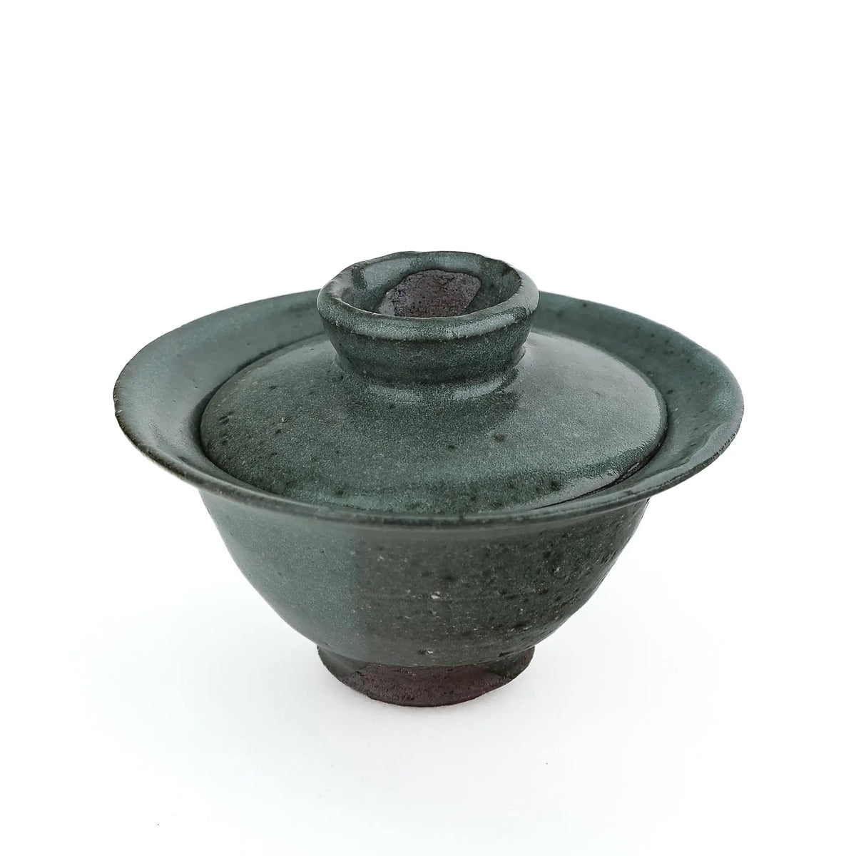 Mark Mohler handmade gaiwan #9 from a slightly raised angle with the lid on, showing the knob and the speckled green glaze on the lid and bowl
